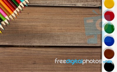 Pencils And Paints On A Background Of Dark Wood Tables Stock Photo