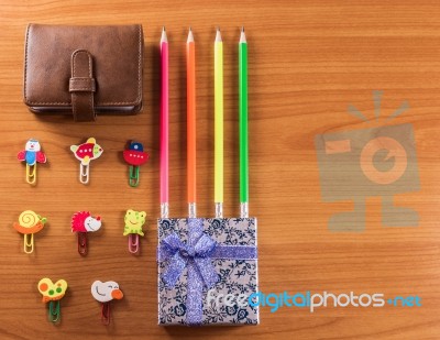 Pencils, Giftbox, Leather Bag And Paperclips Background Stock Photo