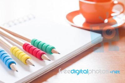 Pencils On Open Blank White Notebook With Coffee Cup On The Desk… Stock Photo