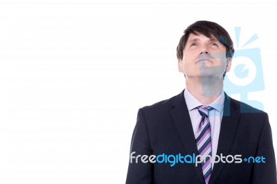 Pensive Business Man Looking Up Stock Photo