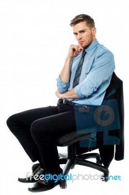 Pensive Businessman Sitting On The Chair Stock Photo