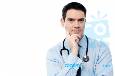 Pensive Physician Looking At Camera Stock Photo