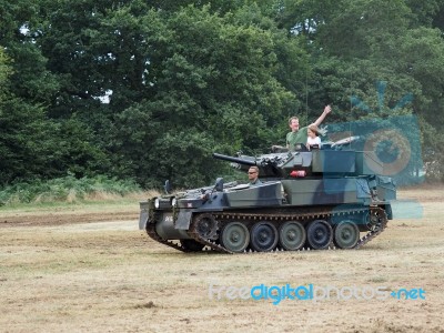 People Enjoying A Ride In An Armoured Car At Dunsfold Airfield Stock Photo