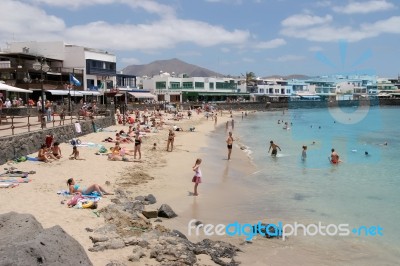 People Enjoying The Beach And Sea At Puerto Del Carmen Stock Photo