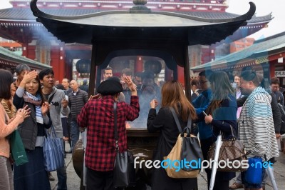 People Fan Incense Smoke At Sensoji Temple Stock Photo