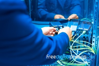 People Fix Core Switch In Network Room Stock Photo