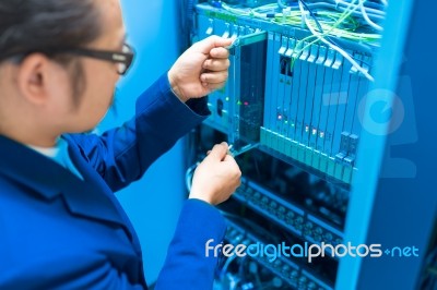 People Fix Node Fiber Optic In Network Room Stock Photo