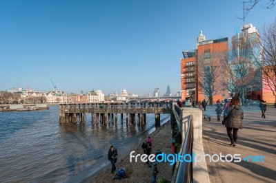 People Relaxing By The River Thames Stock Photo