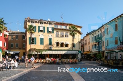 People Relaxing In A Square At Sirmione Lake Garda Stock Photo