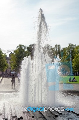 People Relaxing Next To The Fountain At The Cathedral In Berlin Stock Photo