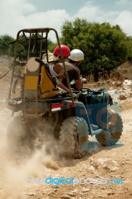 People Riding Quad Bike Stock Photo