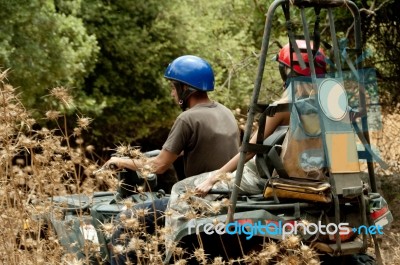 People Riding Quad Bike Stock Photo