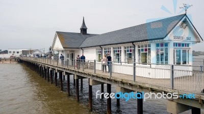 People Strolling Along Southwold Pier Stock Photo