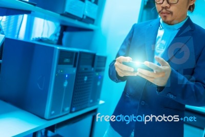 People Use Smart Phone In Datacenter Room Stock Photo