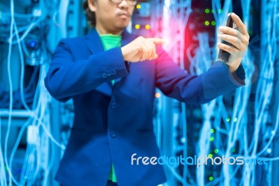 People Use Smart Phone In Datacenter Room Stock Photo