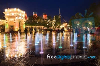 People Visit Night Music Fountain In Disney Sea Stock Photo