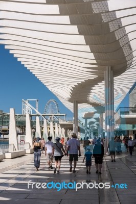 People Walking Under The Modern Pergola In The Harbour Area Of M… Stock Photo