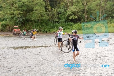 People With Bicycles Are Crossing Rio Cano Negro In Costa Rica Stock Photo