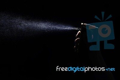 Perfume Spraying On Black Background Stock Photo