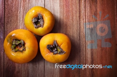 Persimmon Fruit On Wood Table Stock Photo