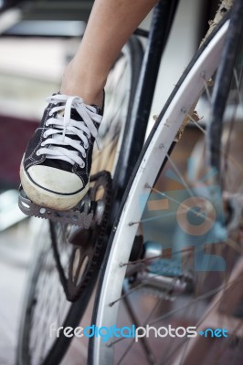 Person Riding A Vintage Bicycle, Close Up View Of Sneaker Shoe A… Stock Photo