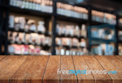 Perspective Top Wooden Table With Blurred Cafe Background Stock Photo