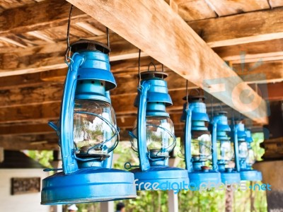 Perspective View Of Storm Lanterns Hanged On Wooden Counterpoise… Stock Photo