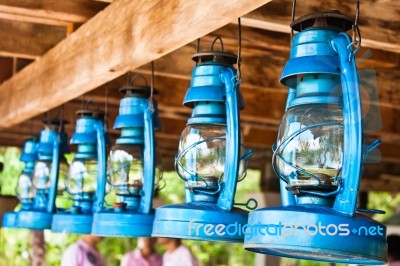 Perspective View Of Storm Lanterns Hanged On Wooden Counterpoise… Stock Photo