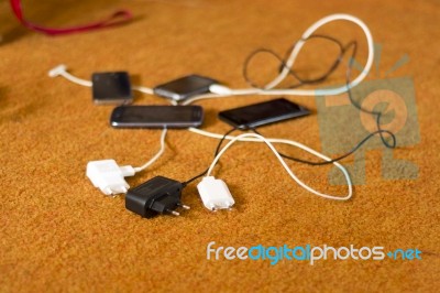 Phone Chargers On The Floor Stock Photo