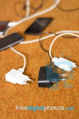 Phone Chargers On The Floor Stock Photo