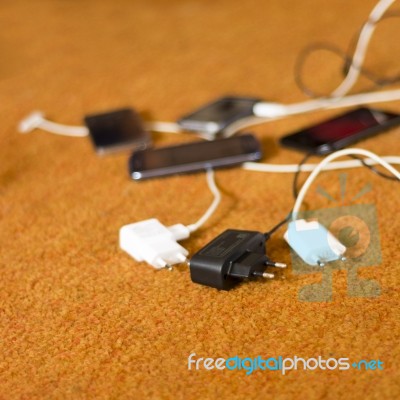 Phone Chargers On The Floor Stock Photo