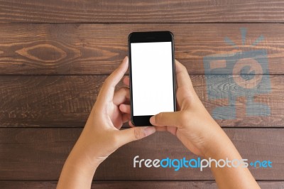 Phone In Woman Hand Showing White Screen On Wood Table, Mockup N… Stock Photo