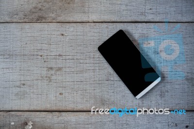 Phone On Wooden Floor Stock Photo