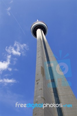 Photo Og The Cn Tower, Blue Sky, Clouds And The Plane Stock Photo