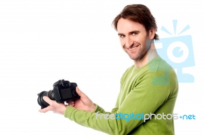 Photographer Resetting The Camera Settings Stock Photo