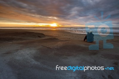 Photographer Taking A Sun Set Photograph On Hokitika Beach South Island New Zealand Stock Photo