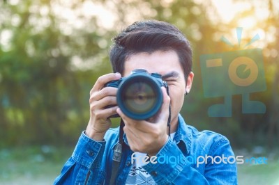 Photographer Taking Pictures With Digital Camera. Vintage Tone Stock Photo