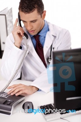 Physician Talking Over Phone Stock Photo