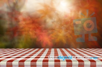 Picnic Table With Blurred Autumn Leaves Background Stock Photo