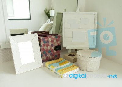 Picture Frame And Book On A Dresser In A Bedroom Stock Photo