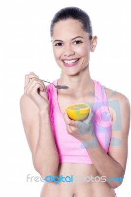 Picture Of Young Woman Eating Orange Stock Photo