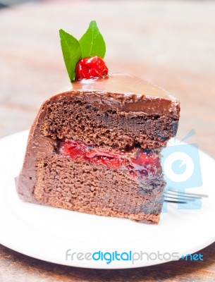 Piece Of Chocolate Cake On White Plate Stock Photo