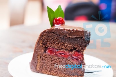 Piece Of Chocolate Cake On White Plate Stock Photo