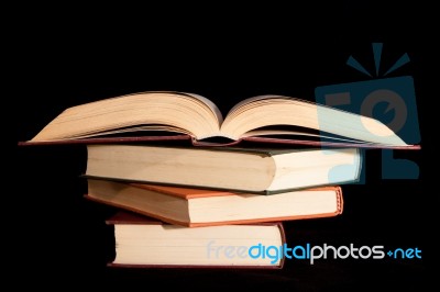 Pile Of Books With A Black Background Stock Photo