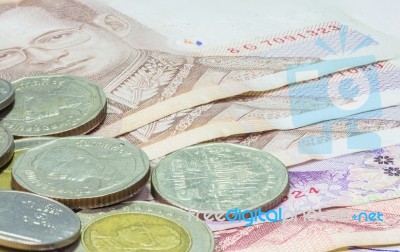 Pile Of Coins And Banknotes Money On White Background Stock Photo