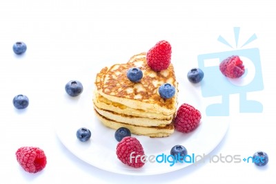 Pile Of Heart Shaped Pancakes With Blueberries And Raspberries Stock Photo