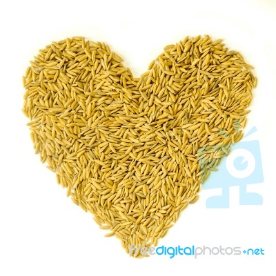 Pile Of Paddy Rice By Heart Shape On The White Background For Isolated Stock Photo