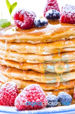 Pile Of Pancakes With Blueberries And Raspberries Sprinkled With… Stock Photo