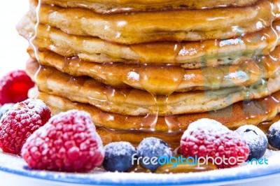 Pile Of Pancakes With Blueberries And Raspberries Sprinkled With… Stock Photo