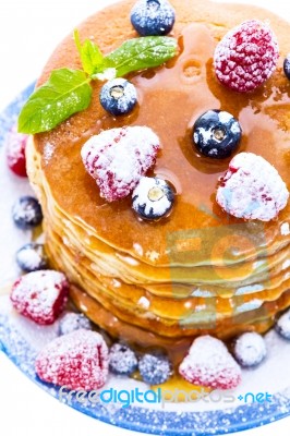 Pile Of Pancakes With Blueberries And Raspberries Sprinkled With… Stock Photo